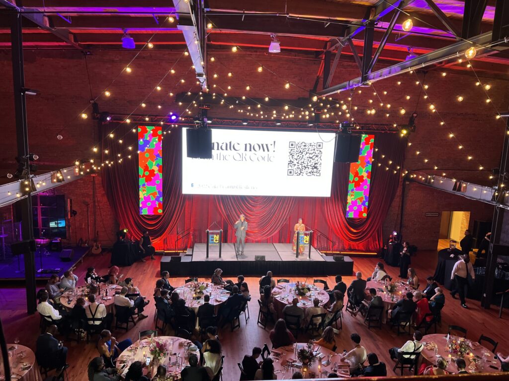 Floating LED wall with Market lights and drape swag. Flying audio, stage set up with dual lecterns and full band set up.