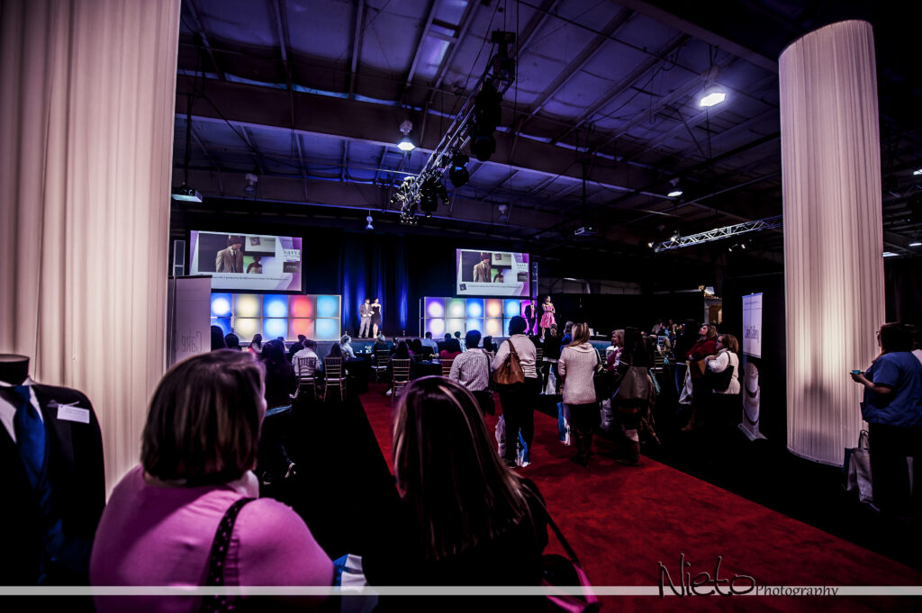 Wedding Show stage set up with dual screen, scenic displays, stage lighting and red carpet runway.